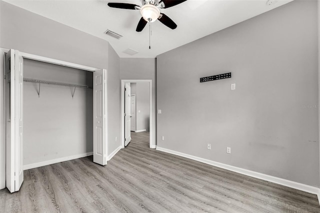 1628 Portofino Meadows Blvd, Orlando, FL 32824 - unfurnished bedroom featuring wood finished floors, a closet, baseboards, and a ceiling fan