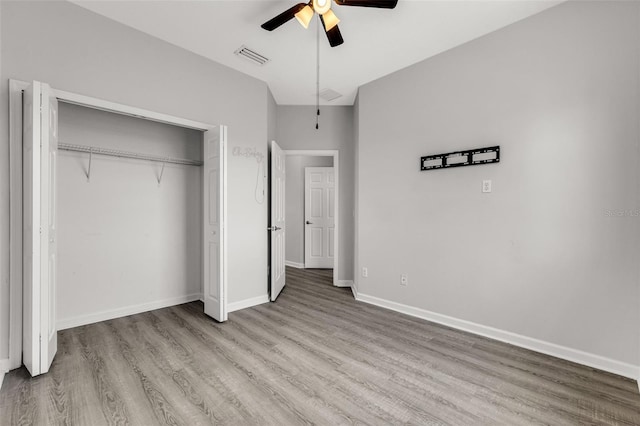 1628 Portofino Meadows Blvd, Orlando, FL 32824 - unfurnished bedroom with wood finished floors, a closet, ceiling fan, and baseboards