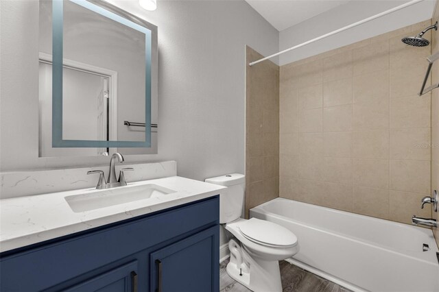 1628 Portofino Meadows Blvd, Orlando, FL 32824 - bathroom with vanity, toilet, bathing tub / shower combination, and wood finished floors