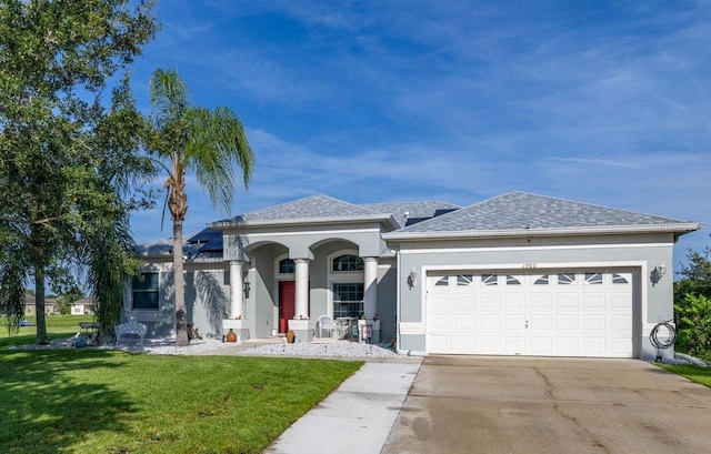 1760 Boat Launch Rd, Kissimmee, FL 34746 - view of front facade with a front yard, an attached garage, concrete driveway, stucco siding, and roof with shingles