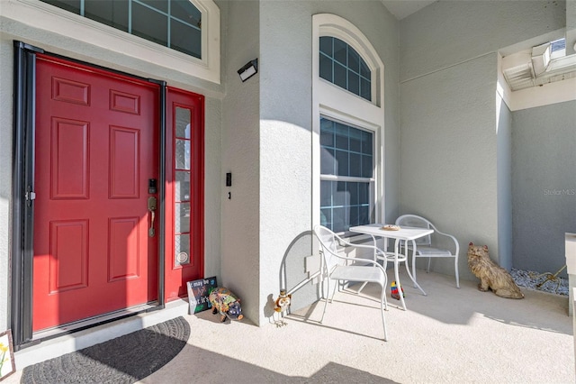 1760 Boat Launch Rd, Kissimmee, FL 34746 - view of exterior entry with stucco siding and a porch