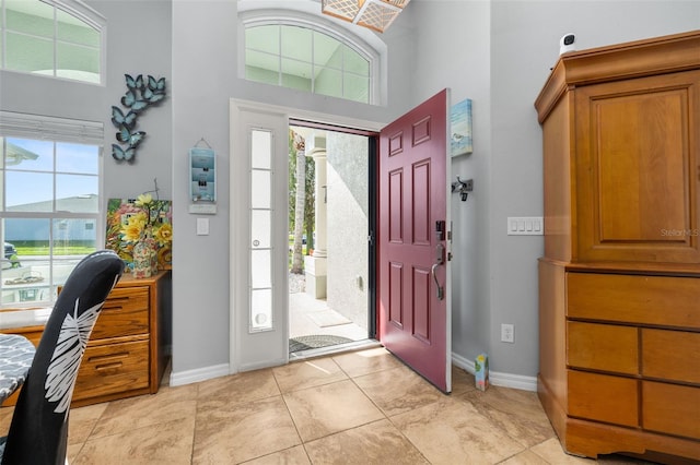 1760 Boat Launch Rd, Kissimmee, FL 34746 - foyer entrance with a towering ceiling, healthy amount of natural light, baseboards, and light tile patterned floors