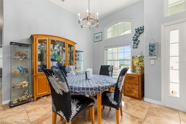 1760 Boat Launch Rd, Kissimmee, FL 34746 - dining room with a towering ceiling, a chandelier, baseboards, and light tile patterned flooring