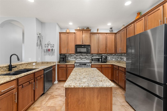 1760 Boat Launch Rd, Kissimmee, FL 34746 - kitchen featuring stainless steel appliances, a sink, brown cabinets, a kitchen island, and recessed lighting