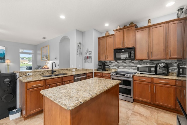 1760 Boat Launch Rd, Kissimmee, FL 34746 - kitchen with stainless steel appliances, a sink, a peninsula, arched walkways, and a center island