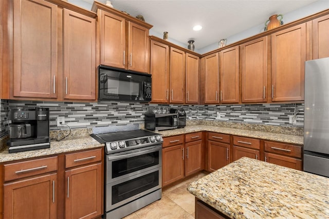 1760 Boat Launch Rd, Kissimmee, FL 34746 - kitchen featuring stainless steel appliances, tasteful backsplash, and brown cabinets