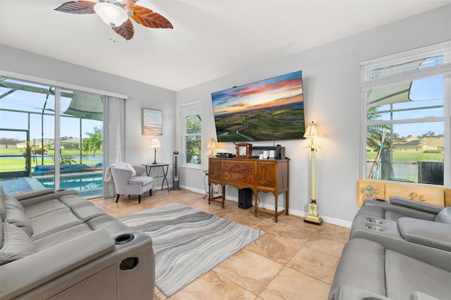1760 Boat Launch Rd, Kissimmee, FL 34746 - living area featuring ceiling fan, baseboards, light tile patterned flooring, and a sunroom
