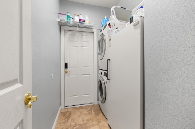 1760 Boat Launch Rd, Kissimmee, FL 34746 - laundry area with stacked washer / drying machine and baseboards