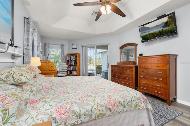 1760 Boat Launch Rd, Kissimmee, FL 34746 - bedroom with wood finished floors, a raised ceiling, access to exterior, a ceiling fan, and baseboards