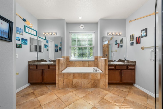 1760 Boat Launch Rd, Kissimmee, FL 34746 - full bathroom featuring two vanities, a garden tub, and a shower stall