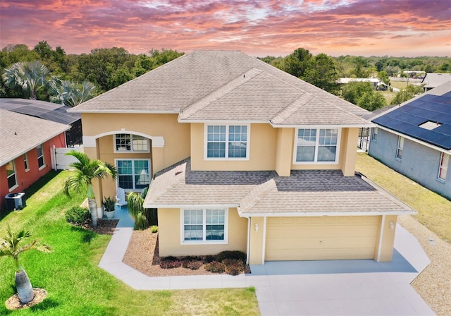 315 Wildflower Rd, Davenport, FL 33837 - traditional home with stucco siding, driveway, roof with shingles, and cooling unit