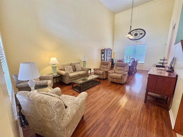 315 Wildflower Rd, Davenport, FL 33837 - living room featuring wood finished floors, a towering ceiling, and baseboards