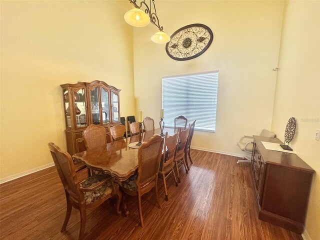 315 Wildflower Rd, Davenport, FL 33837 - dining room featuring a high ceiling, wood finished floors, and baseboards