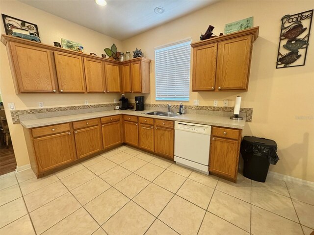 315 Wildflower Rd, Davenport, FL 33837 - kitchen featuring white dishwasher, a sink, brown cabinetry, light countertops, and light tile patterned floors