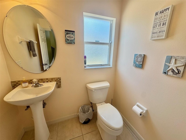 315 Wildflower Rd, Davenport, FL 33837 - bathroom with toilet, baseboards, and tile patterned floors