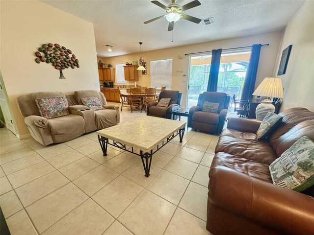 315 Wildflower Rd, Davenport, FL 33837 - living room with light tile patterned flooring, a ceiling fan, and a textured ceiling