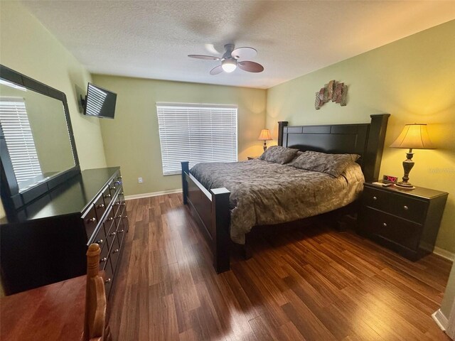 315 Wildflower Rd, Davenport, FL 33837 - bedroom featuring dark wood-type flooring, baseboards, a ceiling fan, and a textured ceiling
