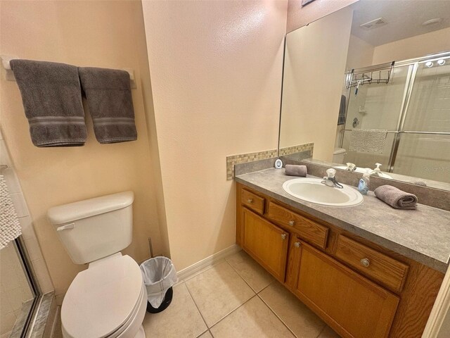 315 Wildflower Rd, Davenport, FL 33837 - full bathroom with toilet, vanity, a stall shower, and tile patterned floors