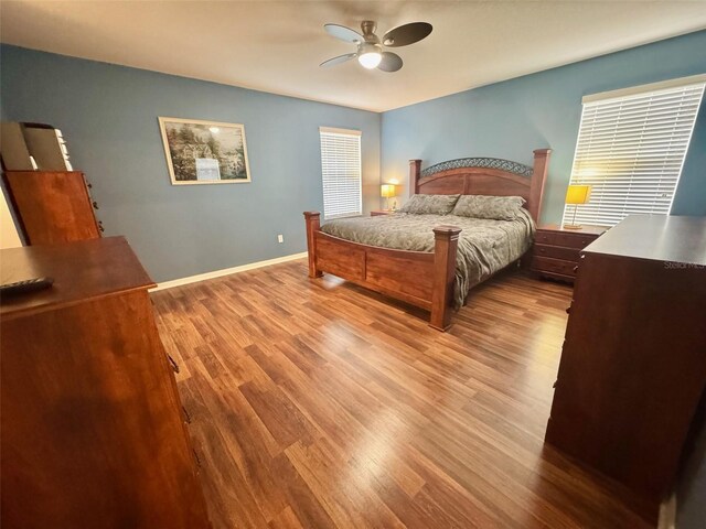 315 Wildflower Rd, Davenport, FL 33837 - bedroom with wood finished floors, baseboards, and a ceiling fan