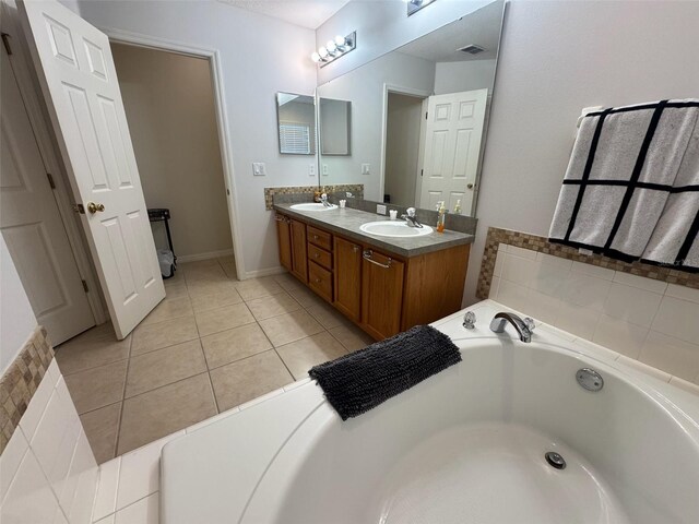 315 Wildflower Rd, Davenport, FL 33837 - full bath featuring double vanity, a bath, and tile patterned flooring