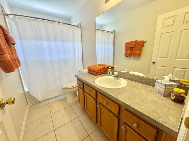 315 Wildflower Rd, Davenport, FL 33837 - full bath featuring vanity, tile patterned flooring, toilet, baseboards, and shower / bath combination with curtain
