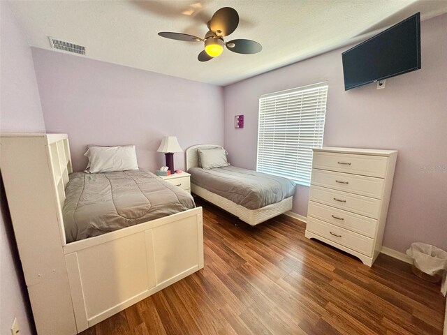315 Wildflower Rd, Davenport, FL 33837 - bedroom featuring wood finished floors, baseboards, and ceiling fan