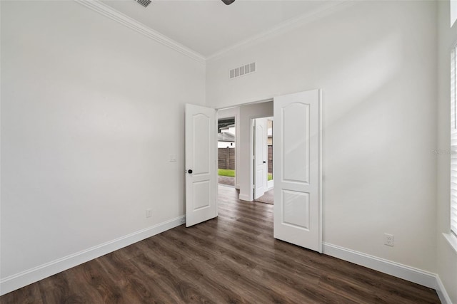 6565 SW 74th Rd, Gainesville, FL 32608 - empty room featuring crown molding, baseboards, dark wood-type flooring, a high ceiling, and a ceiling fan