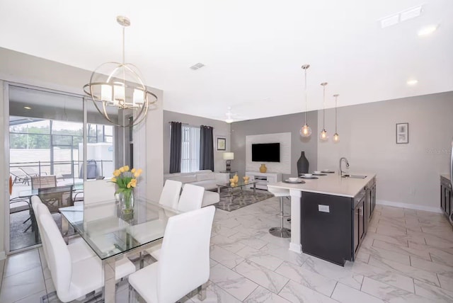 4903 Windermere Ave, Kissimmee, FL 34746 - dining room featuring light marble finish flooring, a chandelier, baseboards, and recessed lighting