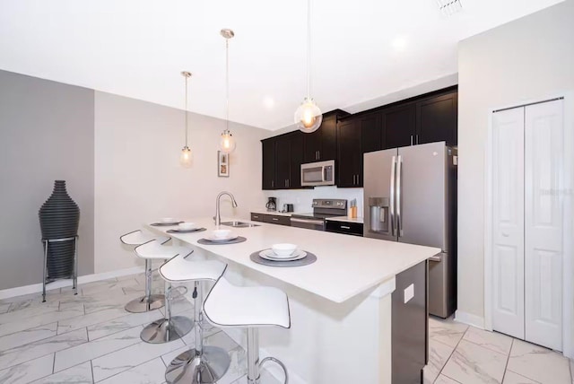 4903 Windermere Ave, Kissimmee, FL 34746 - kitchen with appliances with stainless steel finishes, light marble finish flooring, a sink, light countertops, and a kitchen breakfast bar