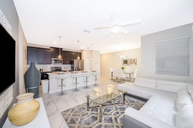 4903 Windermere Ave, Kissimmee, FL 34746 - living room with light marble finish floors and ceiling fan