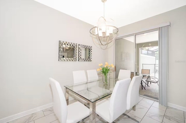 4903 Windermere Ave, Kissimmee, FL 34746 - dining area featuring light marble finish floors, baseboards, and a chandelier