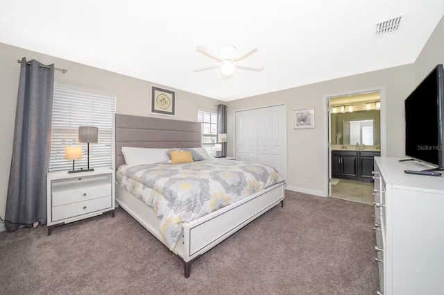 4903 Windermere Ave, Kissimmee, FL 34746 - bedroom with light carpet, a closet, ensuite bathroom, ceiling fan, and baseboards