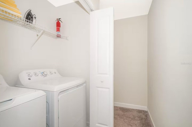 4903 Windermere Ave, Kissimmee, FL 34746 - laundry room featuring washer and clothes dryer, light colored carpet, and baseboards