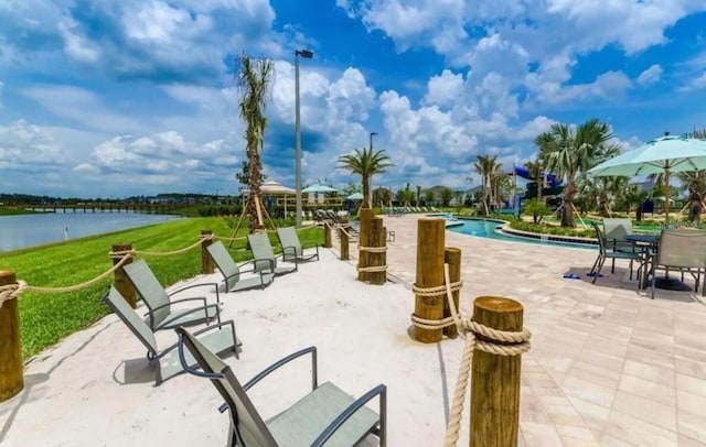 4903 Windermere Ave, Kissimmee, FL 34746 - view of property's community featuring a water view, a patio, a pool, and a yard
