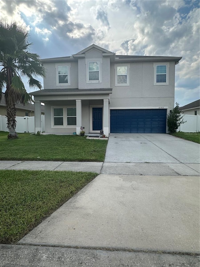 12372 Stone Bark Trl, Orlando, FL 32824 - traditional-style home with an attached garage, stucco siding, and concrete driveway