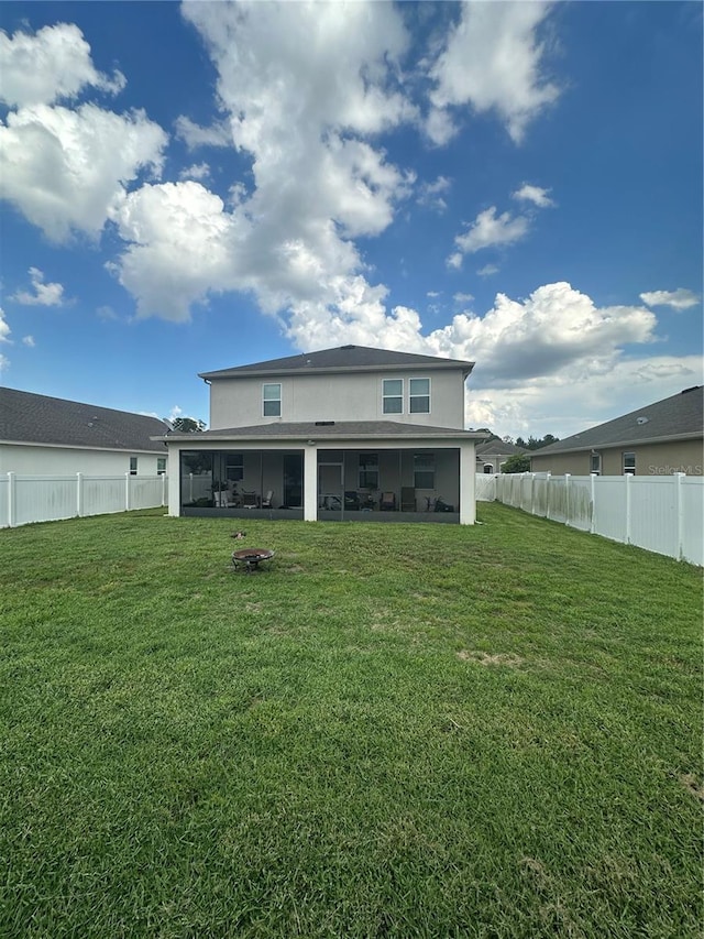 12372 Stone Bark Trl, Orlando, FL 32824 - rear view of house featuring a sunroom, stucco siding, and a fenced backyard