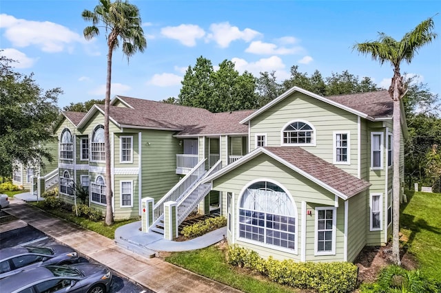 3151 Britannia Blvd Unit C, Kissimmee, FL 34747 - view of front of property with a shingled roof and stairway