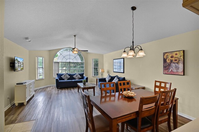 3151 Britannia Blvd Unit C, Kissimmee, FL 34747 - dining room with wood finished floors, ceiling fan, vaulted ceiling, a chandelier, and baseboards