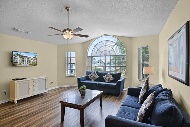 3151 Britannia Blvd Unit C, Kissimmee, FL 34747 - living room with wood finished floors, ceiling fan, a textured ceiling, baseboards, and lofted ceiling