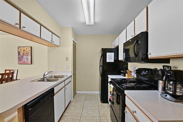 3151 Britannia Blvd Unit C, Kissimmee, FL 34747 - kitchen with black appliances, a sink, white cabinets, a textured ceiling, and light countertops