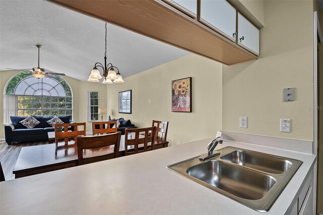 3151 Britannia Blvd Unit C, Kissimmee, FL 34747 - kitchen featuring a sink, light countertops, open floor plan, decorative light fixtures, and ceiling fan