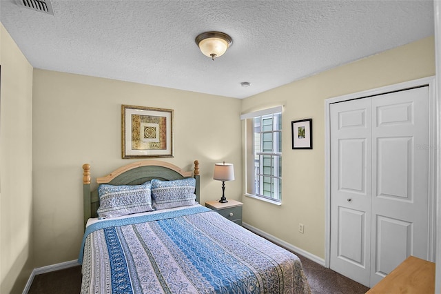 3151 Britannia Blvd Unit C, Kissimmee, FL 34747 - bedroom featuring dark carpet, baseboards, a textured ceiling, and a closet