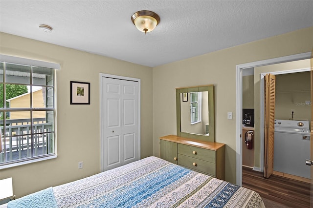 3151 Britannia Blvd Unit C, Kissimmee, FL 34747 - bedroom featuring washer / dryer, dark wood-style flooring, a textured ceiling, and baseboards