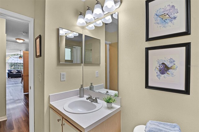 3151 Britannia Blvd Unit C, Kissimmee, FL 34747 - bathroom featuring a chandelier, vanity, wood finished floors, and toilet