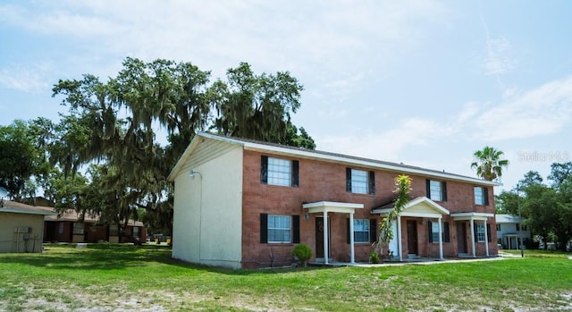 201 Century Blvd Unit A, Auburndale, FL 33823 - view of front facade with a front yard and brick siding