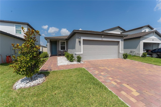 3442 Monaco Ln, Davenport, FL 33897 - single story home with stucco siding, decorative driveway, a front yard, and an attached garage