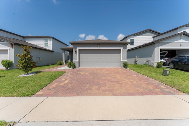 3442 Monaco Ln, Davenport, FL 33897 - view of front of home featuring decorative driveway, a front lawn, a garage, and stucco siding