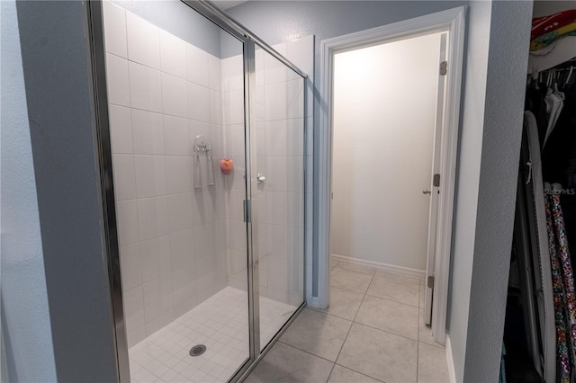3442 Monaco Ln, Davenport, FL 33897 - bathroom with a walk in closet, a stall shower, and tile patterned flooring