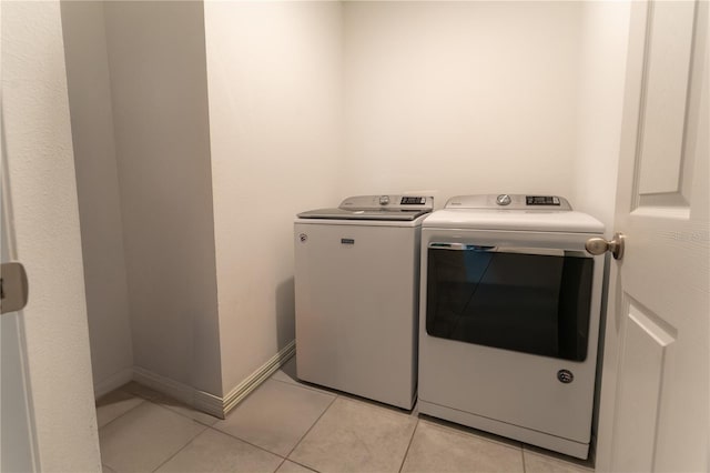 3442 Monaco Ln, Davenport, FL 33897 - laundry area with separate washer and dryer and light tile patterned flooring