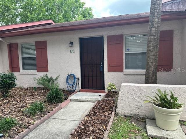 13 W Marbrisa Way, Kissimmee, FL 34743 - view of exterior entry featuring stucco siding